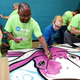 Tennessean reporter Getahn Ward, left, and Olivia Cass, daughter of TN Media Marketing Manager Heather Cass, paint an octopus for a children’s mural during Make A Difference Day on Oct. 24, 2015. (Shelley Mays/Tennessean)